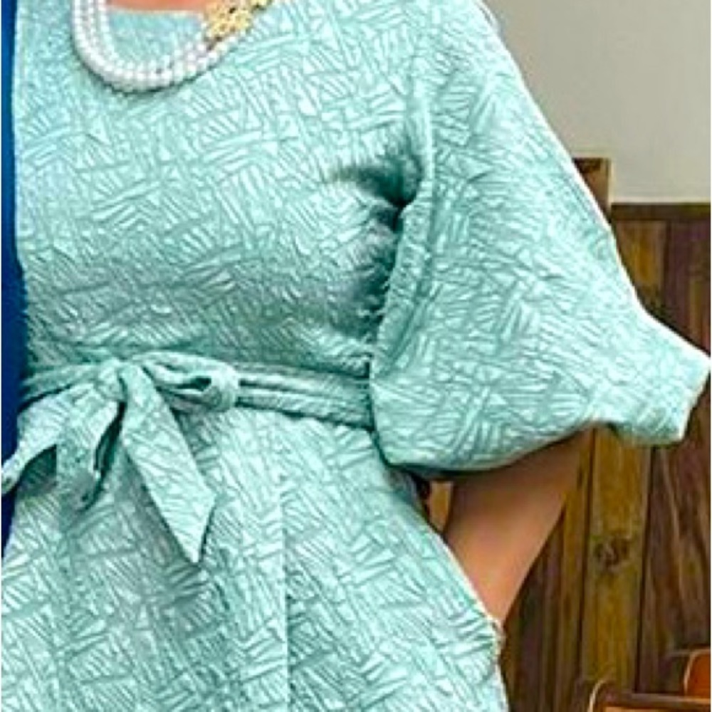 Mint green dress with pockets and belt.